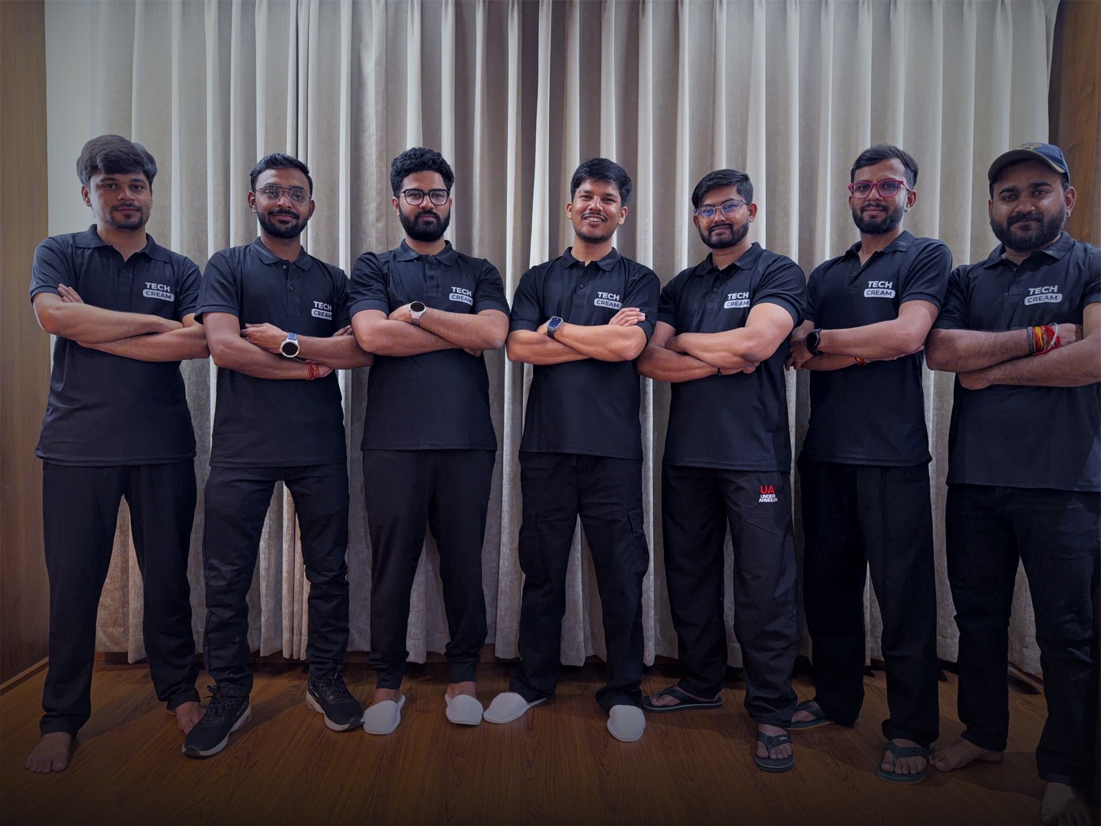 Seven members of the Techcream team standing in a row in matching black Techcream polos